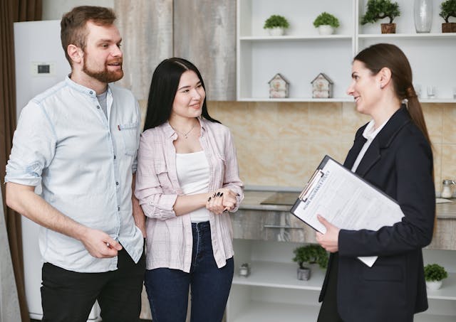 a property manager meeting with tenants inside a house