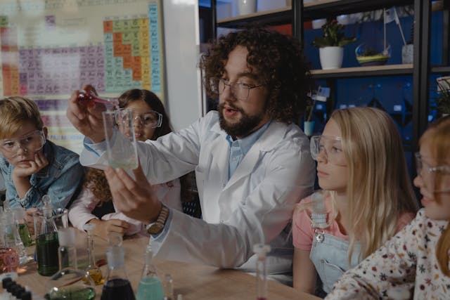 children gathering around a teacher doing a science experiment